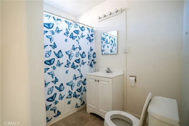 a bathroom with a sink and mirror with toilet