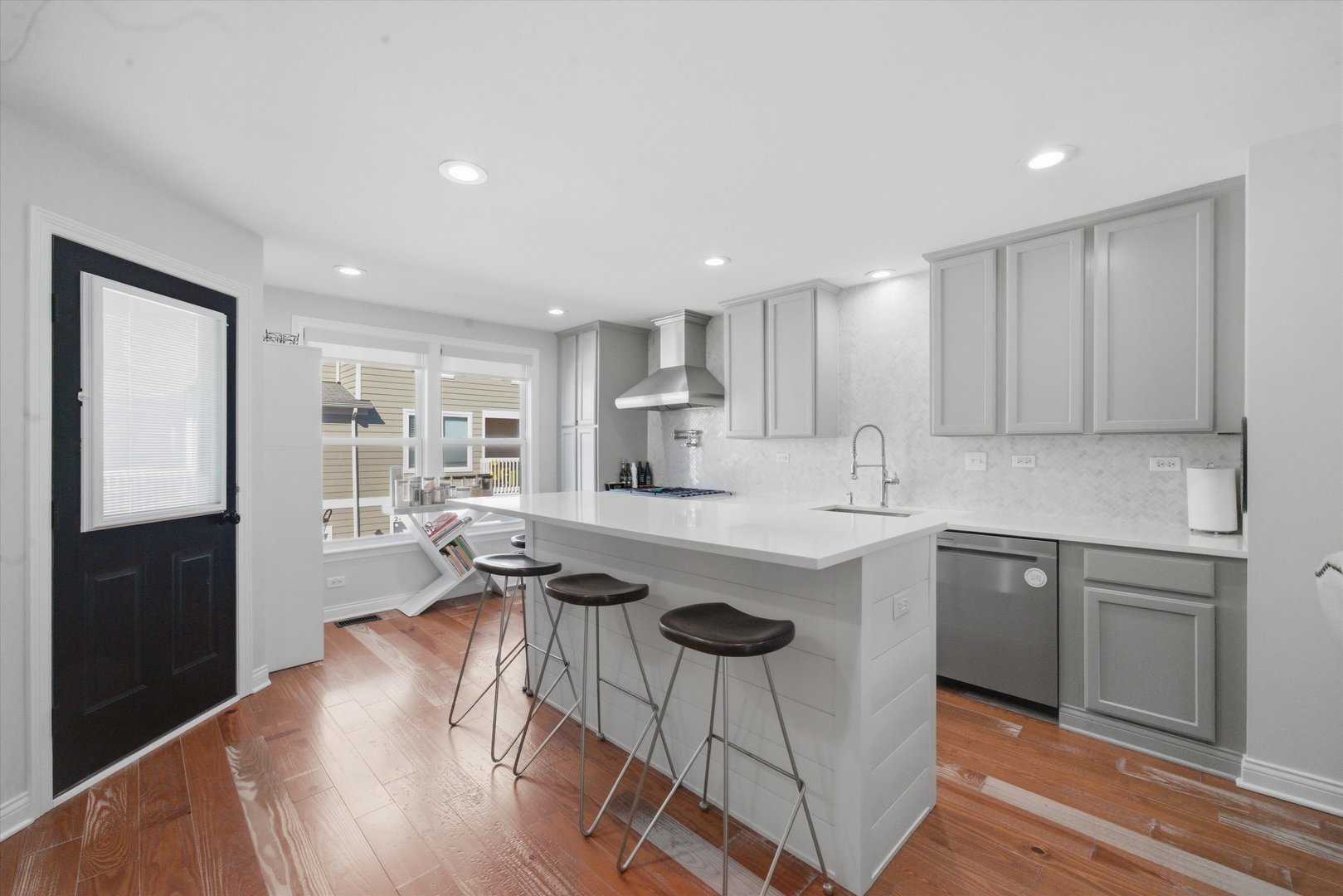2448 Emily Lane Elgin, IL 60124 - Photo 9 of 34 a kitchen with kitchen island a sink table and chairs