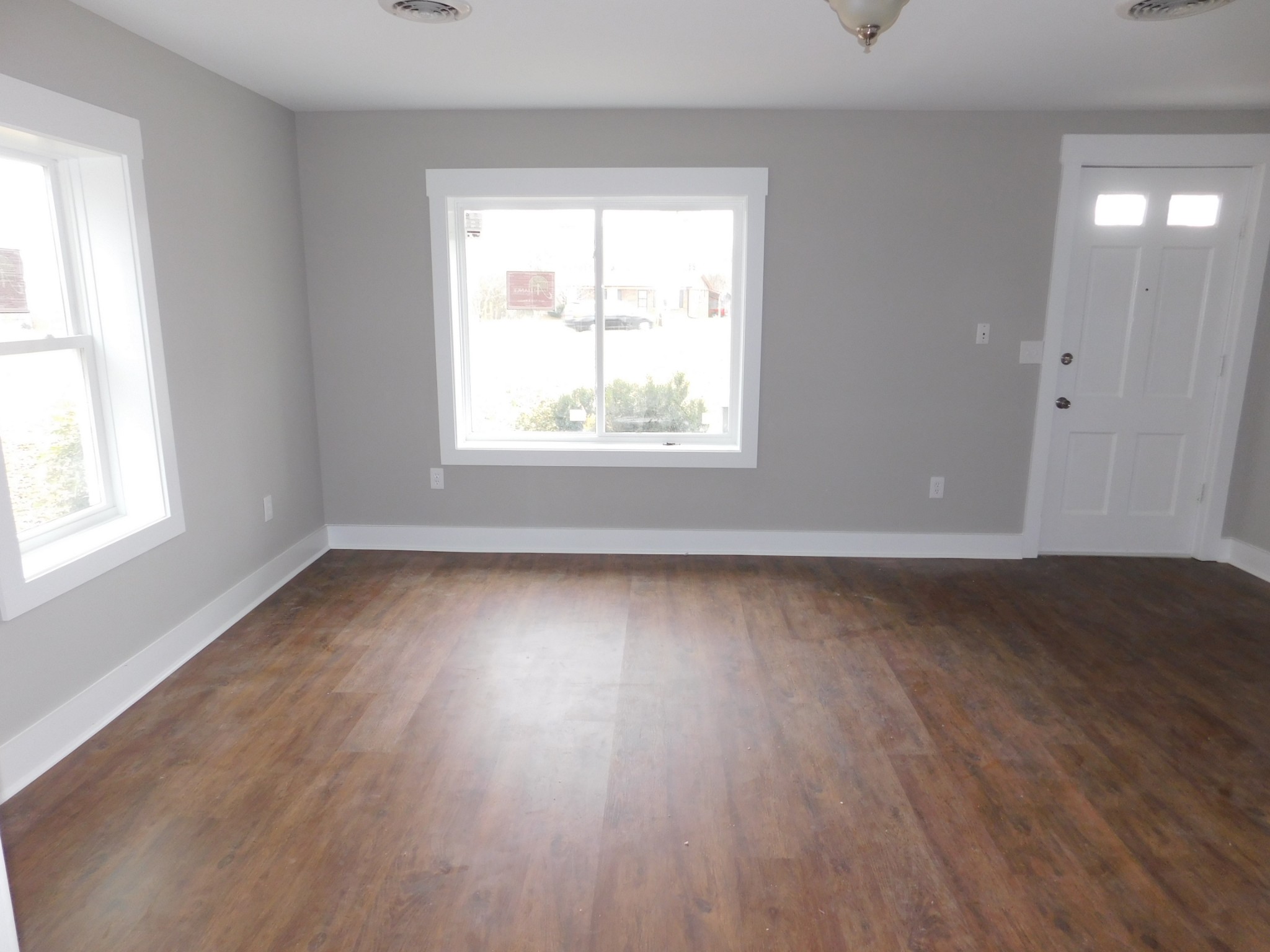 736 Riley Creek Road Tullahoma, TN 37388 - Photo 4 of 25 an empty room with wooden floor and windows