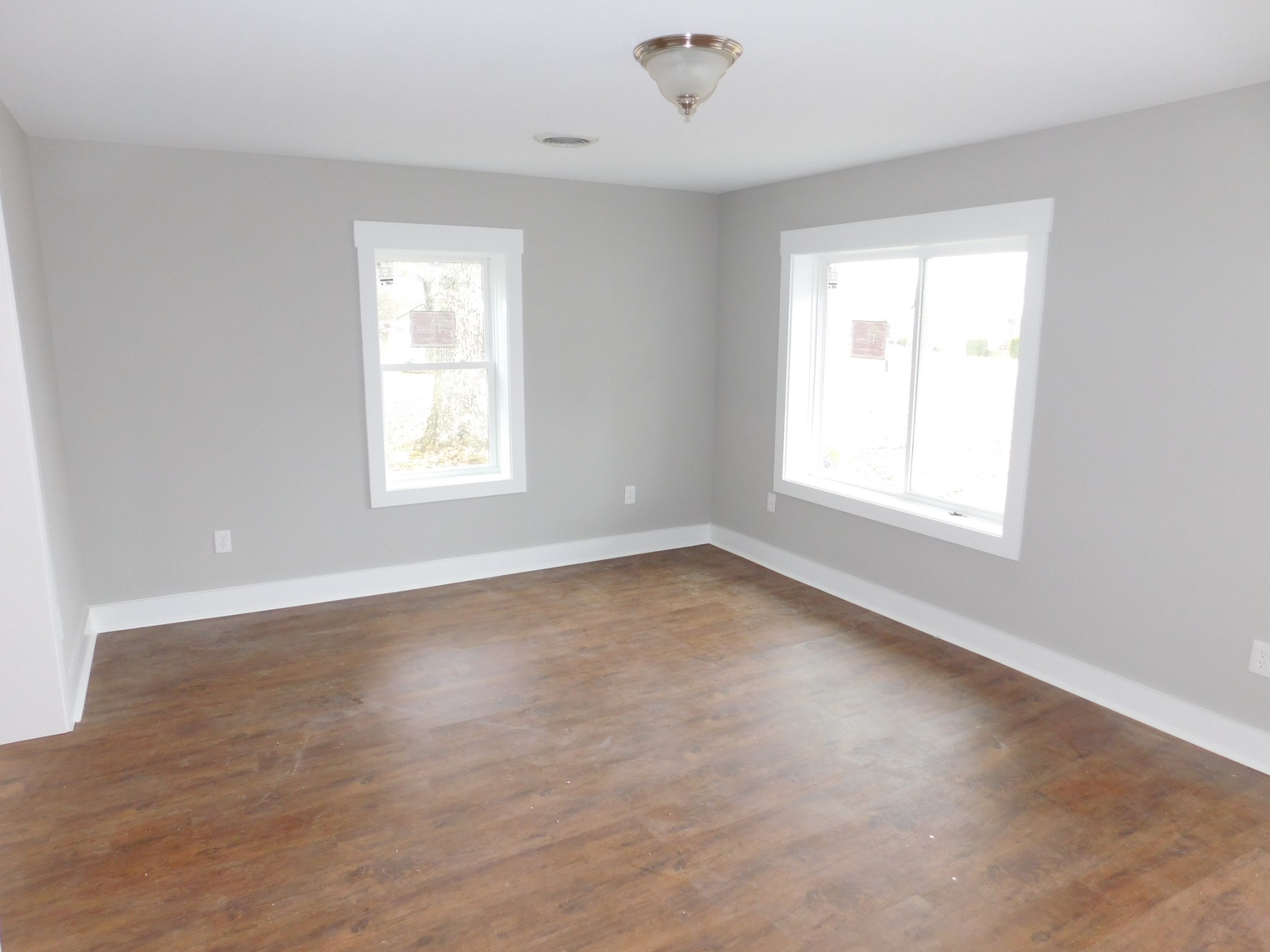 736 Riley Creek Road Tullahoma, TN 37388 - Photo 5 of 25 an empty room with wooden floor and windows