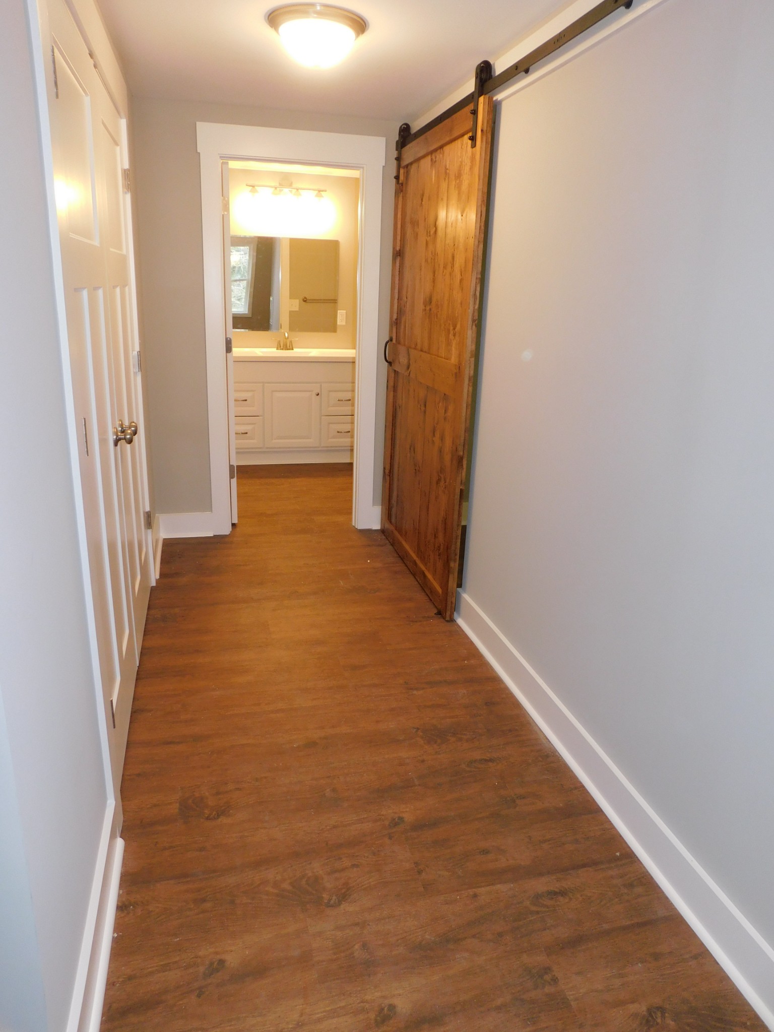 736 Riley Creek Road Tullahoma, TN 37388 - Photo 6 of 25 a view of hallway with a large window and wooden floor