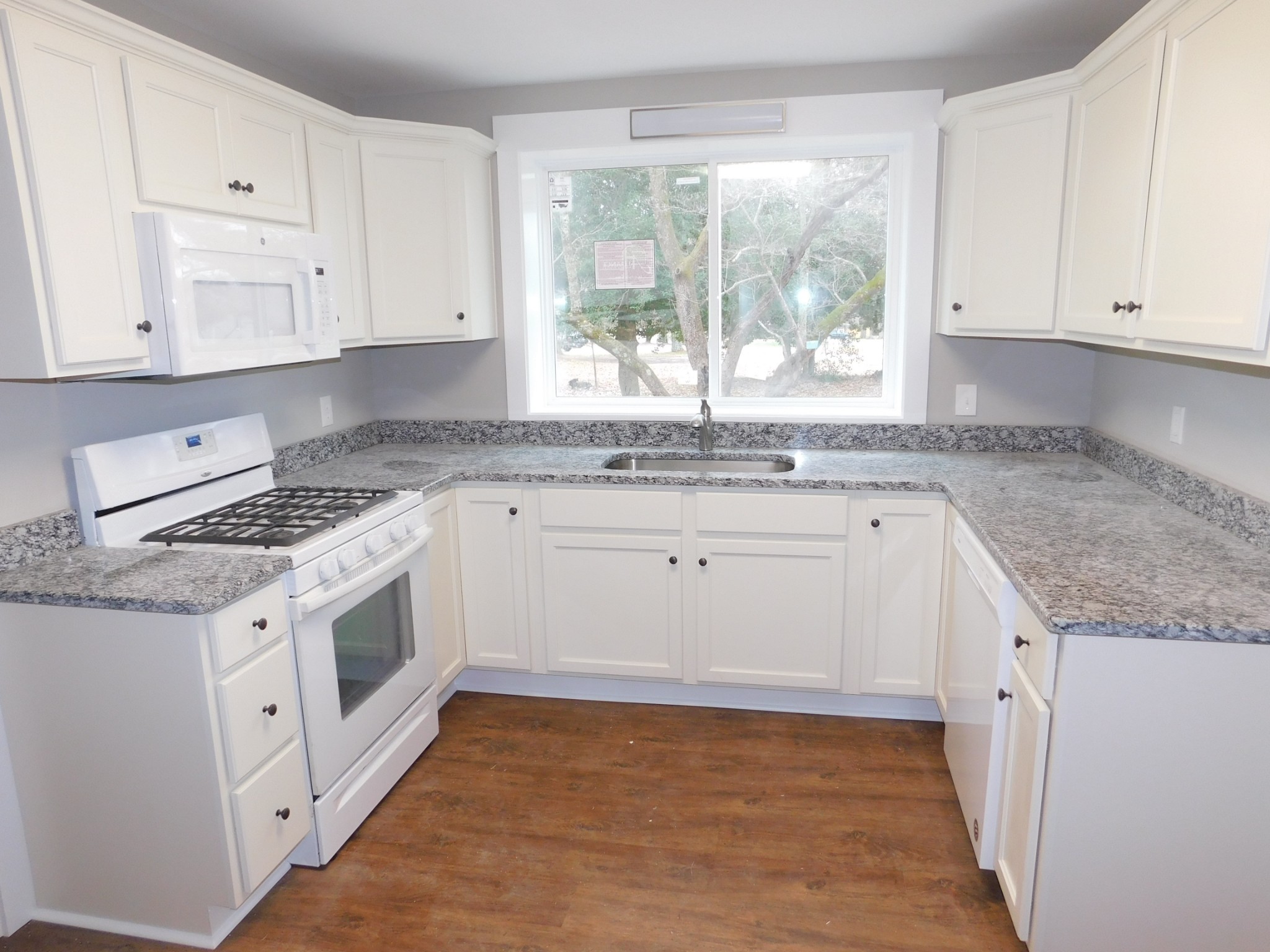 736 Riley Creek Road Tullahoma, TN 37388 - Photo 7 of 25 a kitchen with granite countertop white cabinets and white appliances