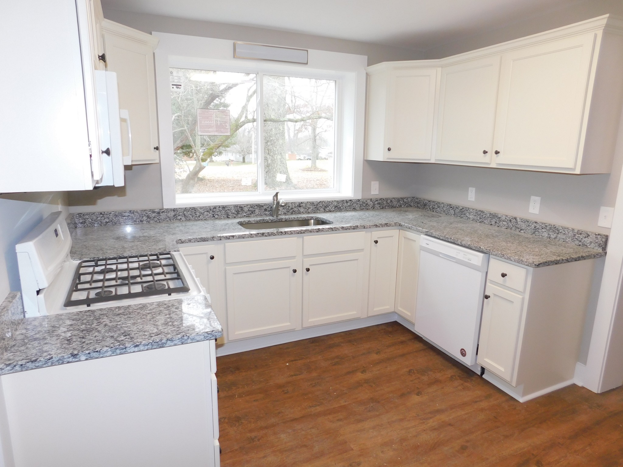736 Riley Creek Road Tullahoma, TN 37388 - Photo 8 of 25 a kitchen with granite countertop a sink stove and cabinets