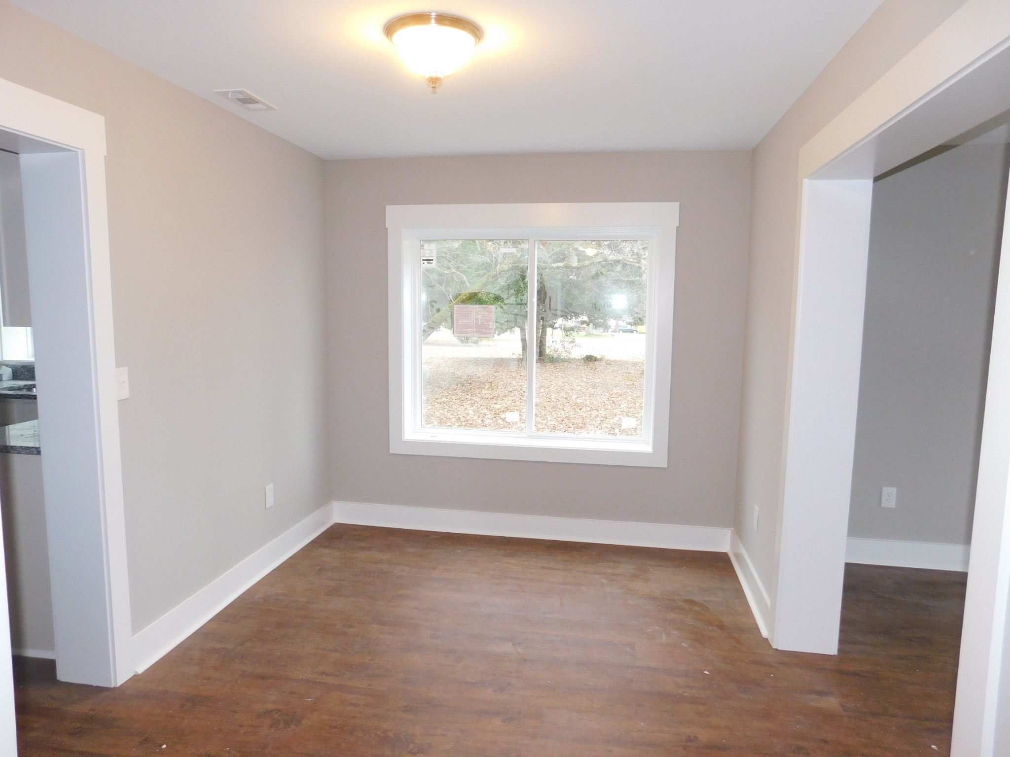 736 Riley Creek Road Tullahoma, TN 37388 - Photo 10 of 25 an empty room with wooden floor and windows