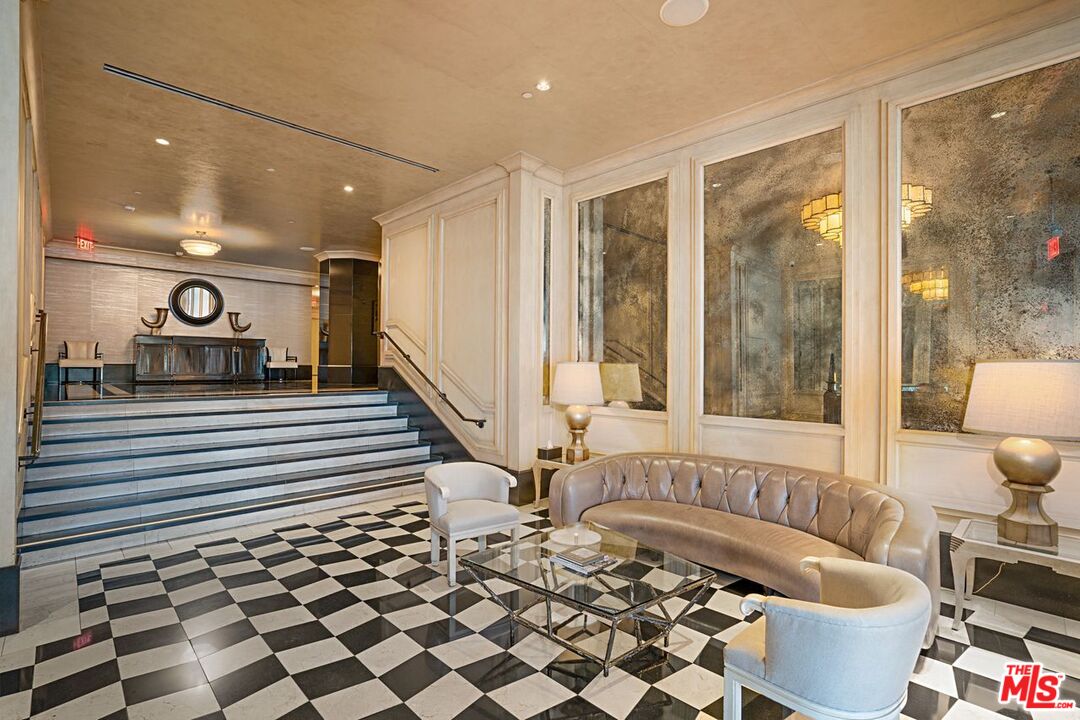 1645 Vine Street, Unit 703 Los Angeles, CA 90028 - Photo 1 of 44 a living room with a black white checkered floor with a dining table and chair