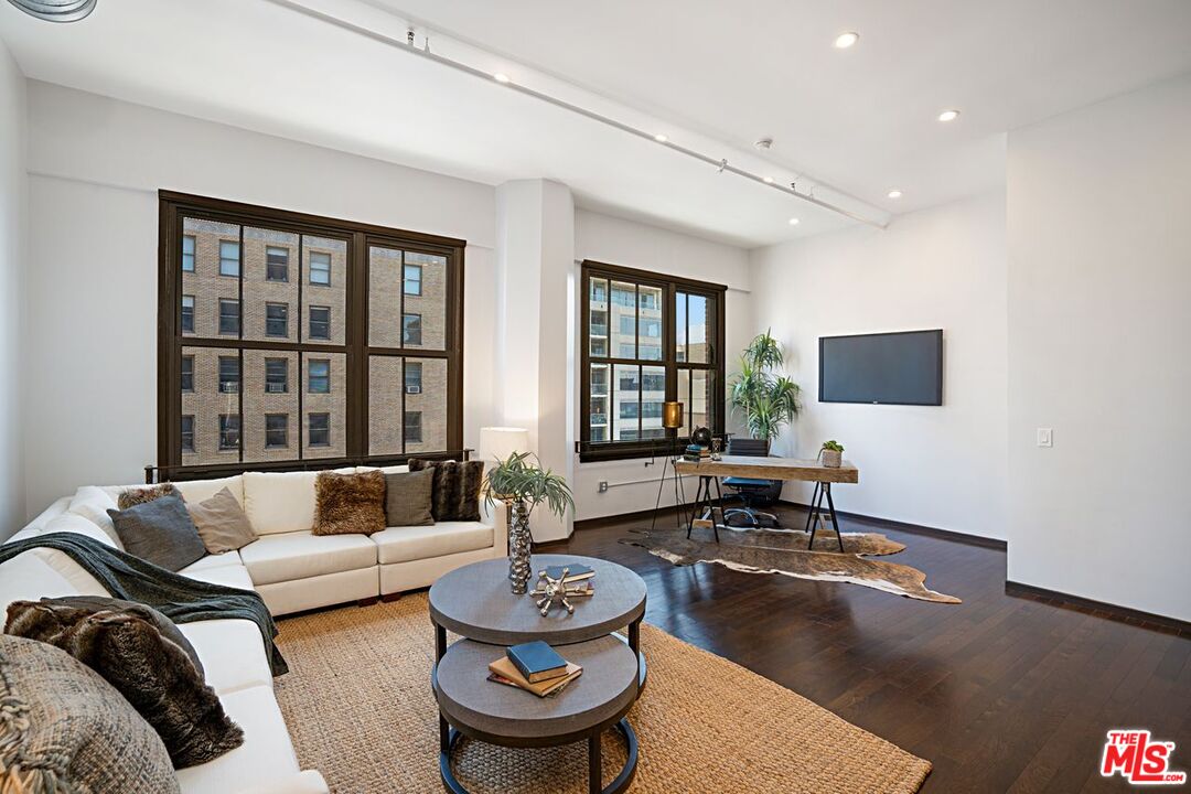 1645 Vine Street, Unit 703 Los Angeles, CA 90028 - Photo 15 of 44 a living room with furniture and a flat screen tv