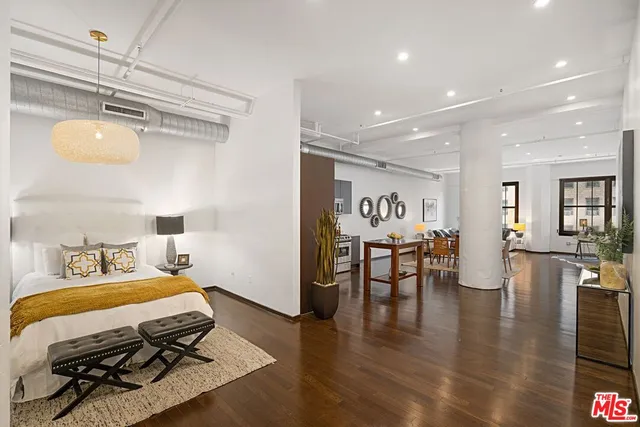 a bedroom with furniture and wooden floor
