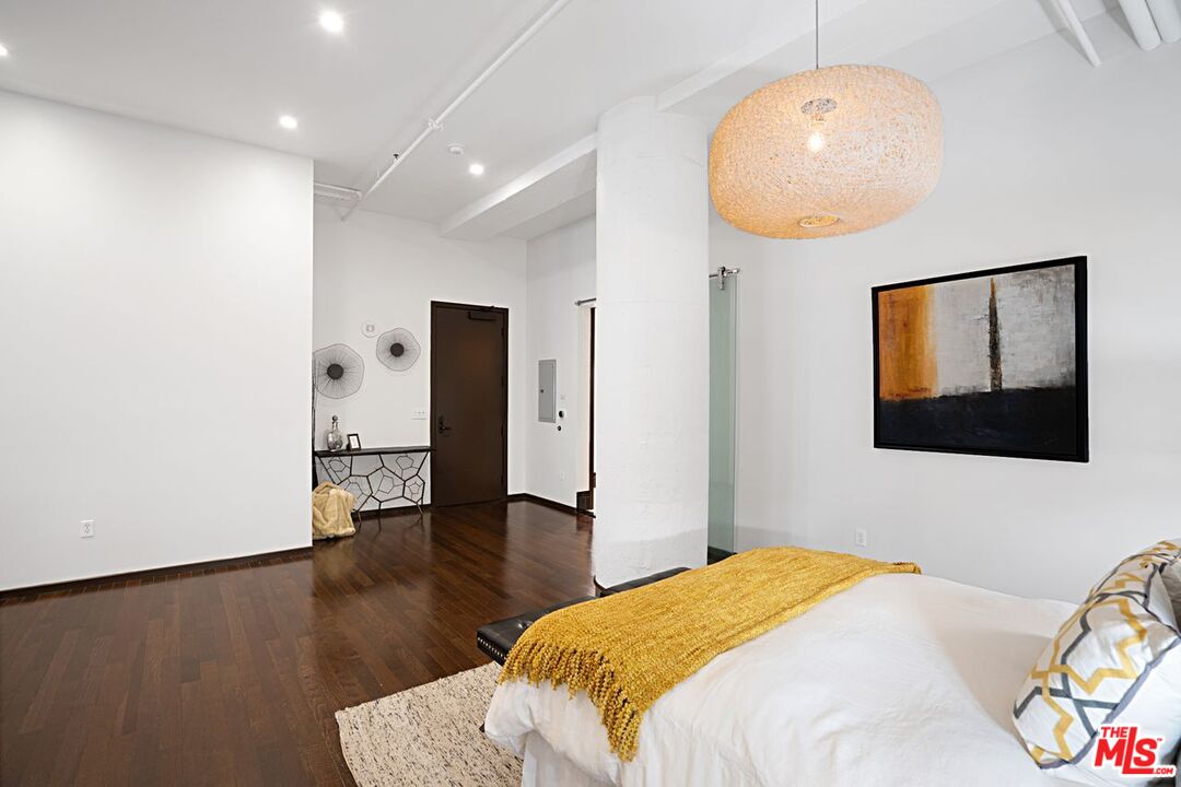 1645 Vine Street, Unit 703 Los Angeles, CA 90028 - Photo 21 of 44 a bedroom with a bed and a chandelier