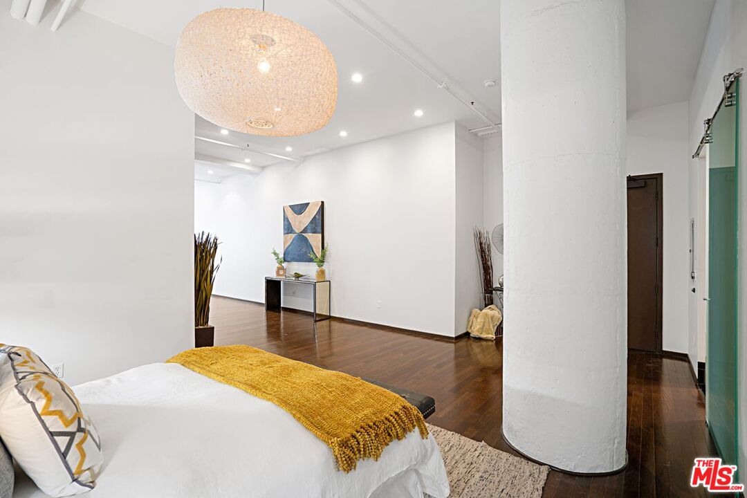 1645 Vine Street, Unit 703 Los Angeles, CA 90028 - Photo 22 of 44 a bedroom with a bed and a large mirror