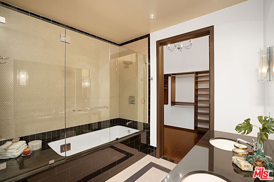 1645 Vine Street, Unit 703 Los Angeles, CA 90028 - Photo 24 of 44 a bathroom with a sink a mirror and a shower