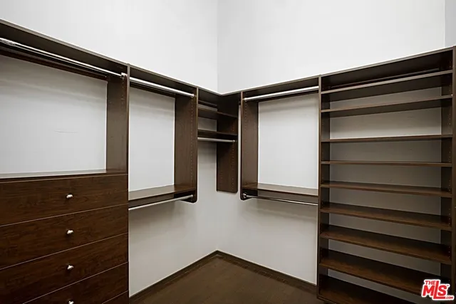 a long hallway with furniture and a chandelier