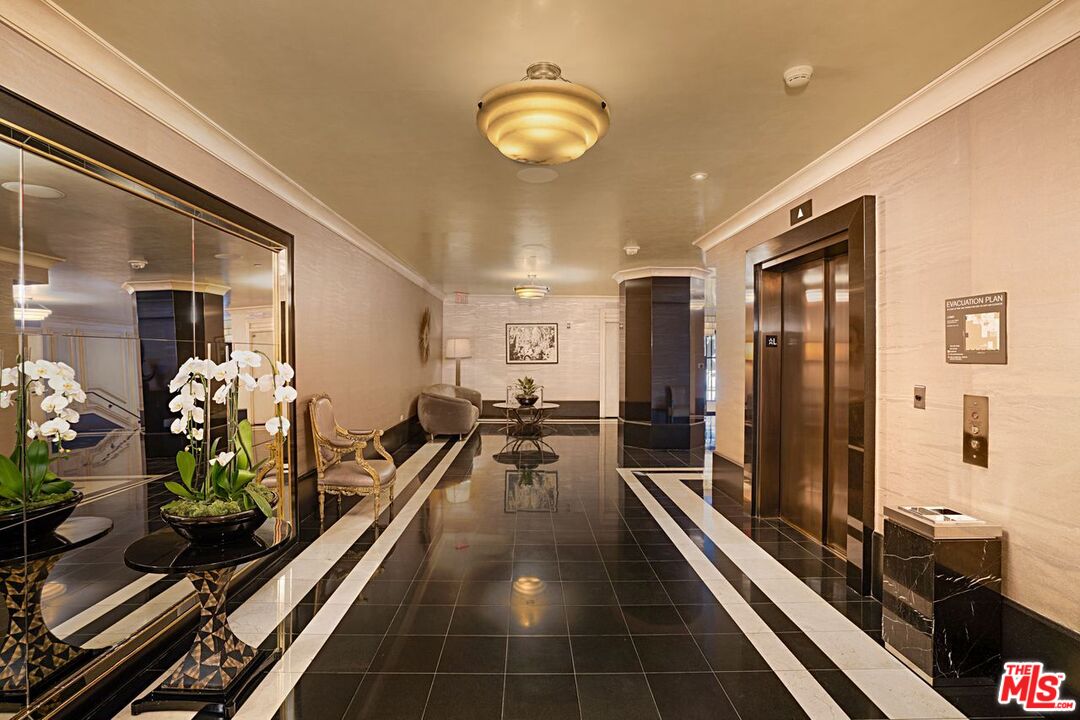 1645 Vine Street, Unit 703 Los Angeles, CA 90028 - Photo 26 of 44 a long hallway with furniture and a chandelier