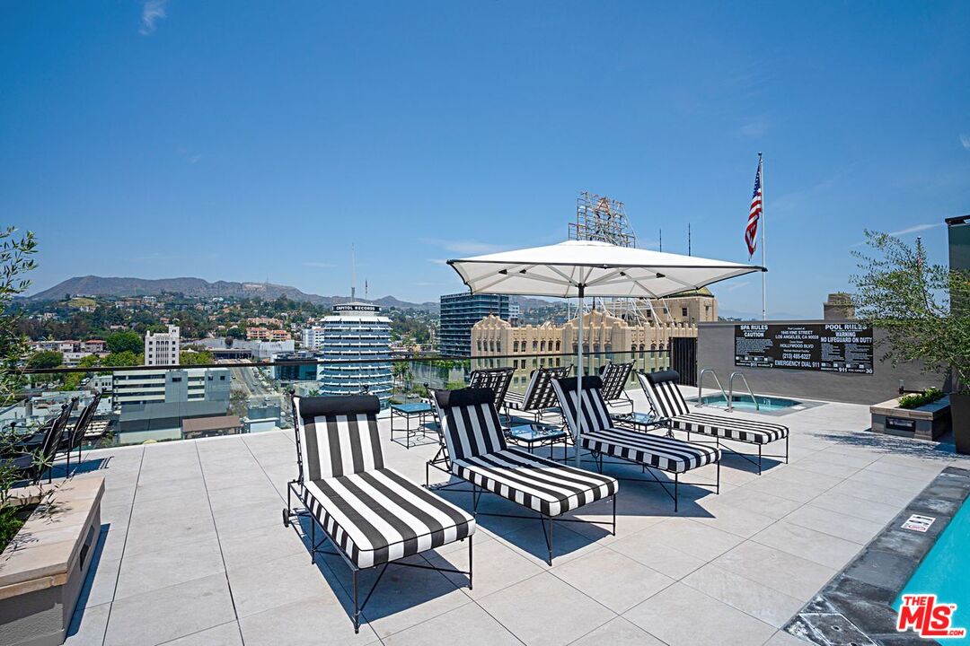 1645 Vine Street, Unit 703 Los Angeles, CA 90028 - Photo 30 of 44 a view of a patio with a dining table and chairs with wooden floor