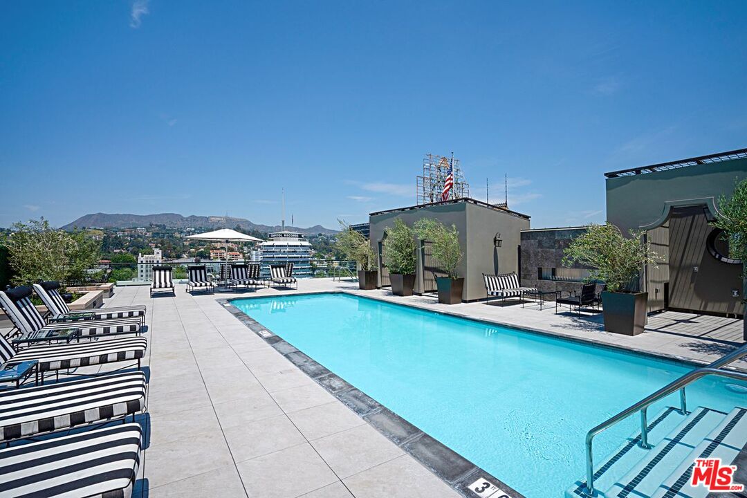 1645 Vine Street, Unit 703 Los Angeles, CA 90028 - Photo 33 of 44 a view of a swimming pool with outdoor seating and plants
