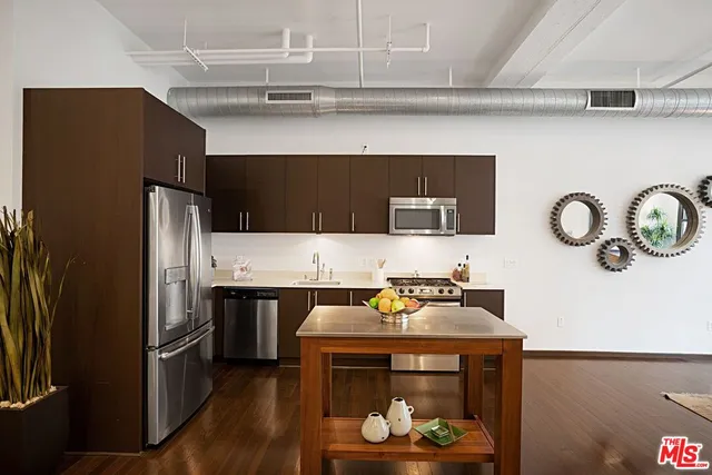 a kitchen with a refrigerator and a stove