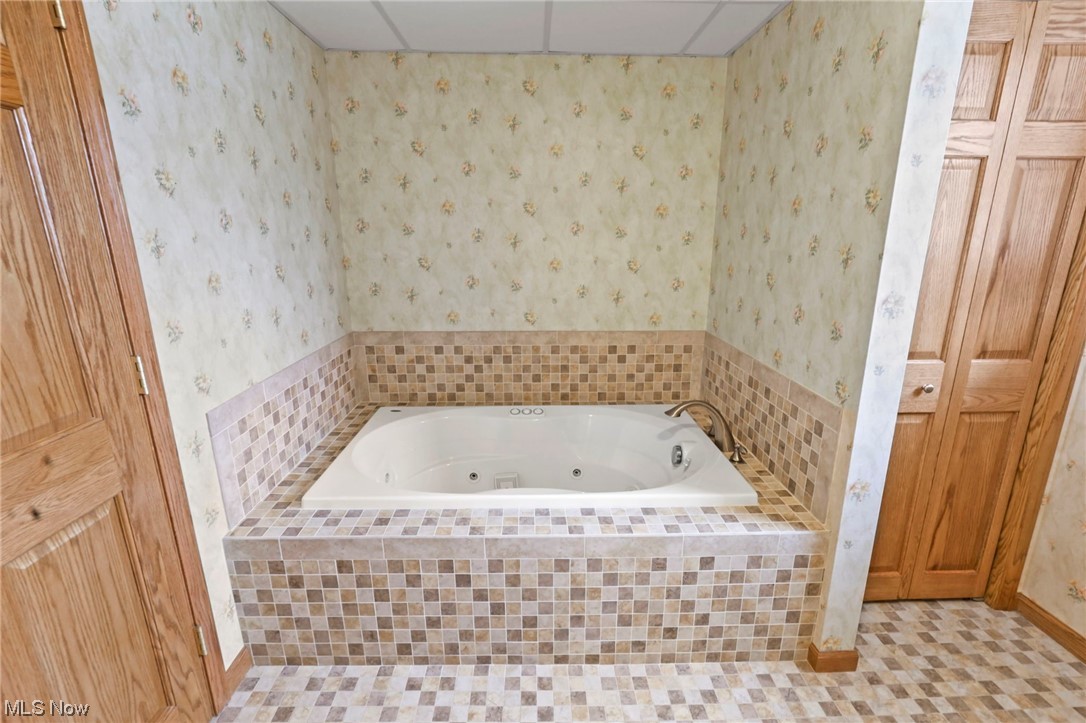 411 Adario West Road Shiloh, OH 44878 - Photo 16 of 35 Bathroom featuring a relaxing tiled bath and tile floors