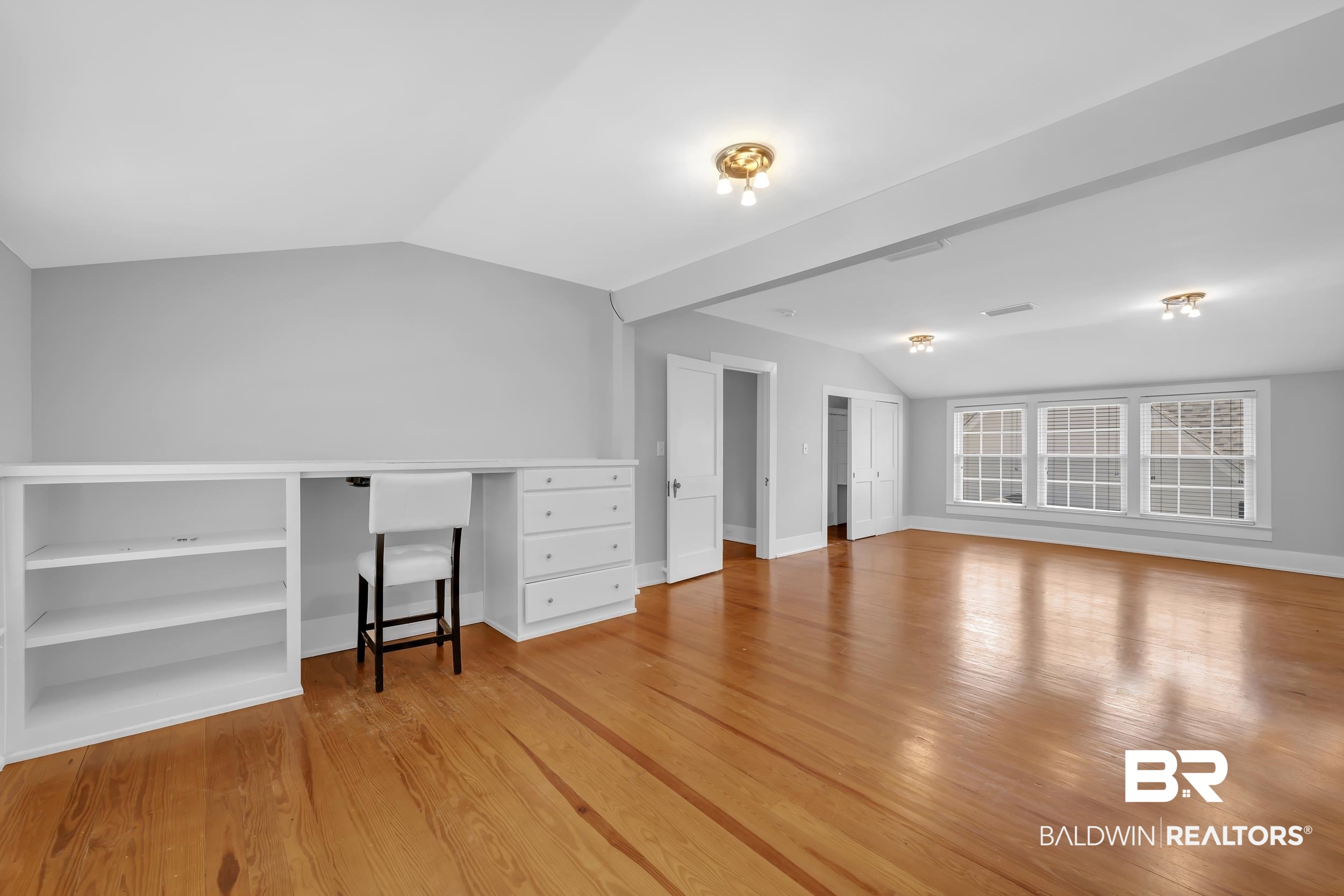 43199 Pine Grove Road Bay Minette, AL 36507 - Photo 67 of 71 Spacious room featuring wood-finish flooring, built-in shelving, integrated desk, and multiple windows