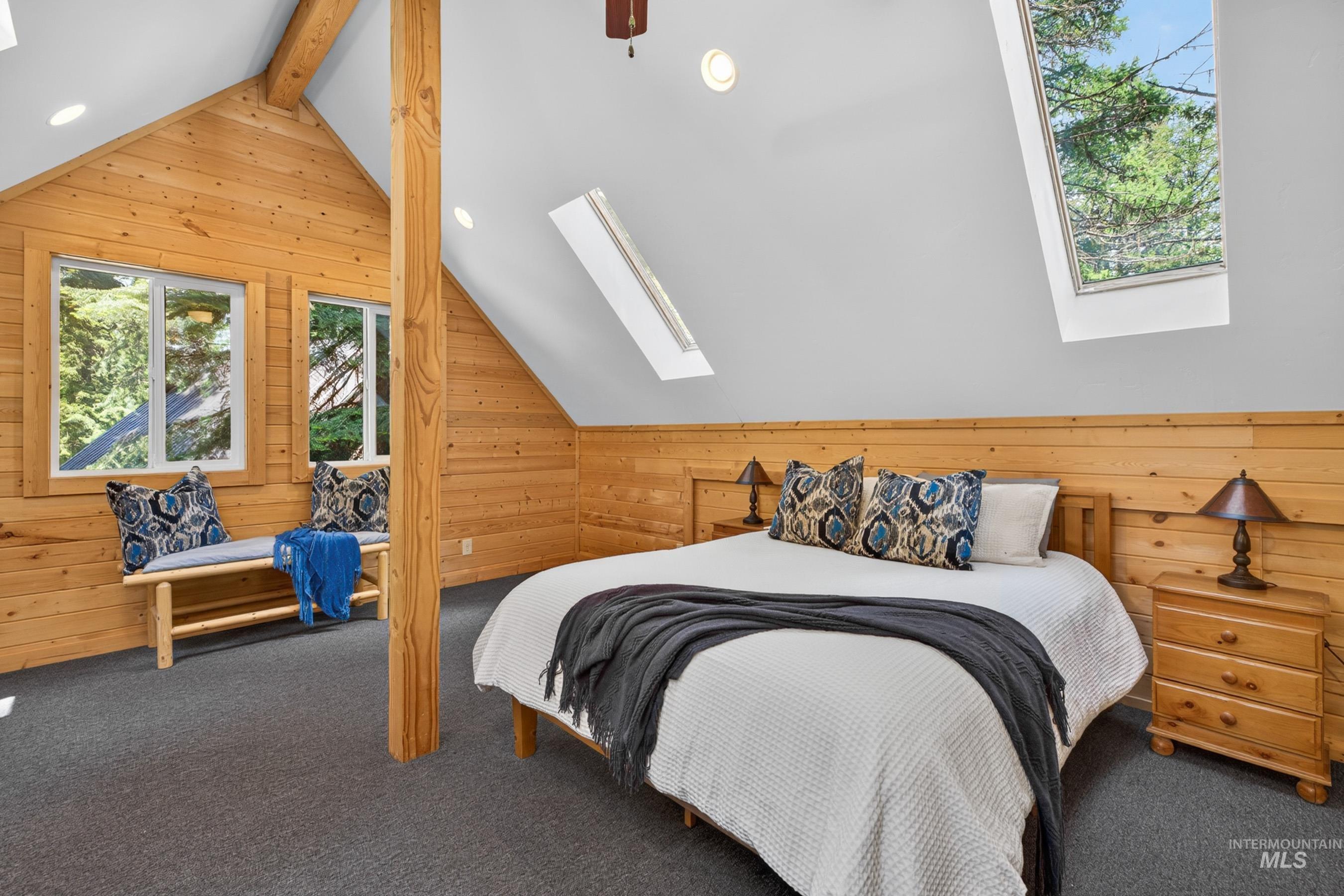 2339 West Mountain Road Donnelly, ID 83615 - Photo 27 of 37 Vaulted ceiling room featuring natural wood paneling, multiple windows, and two skylights