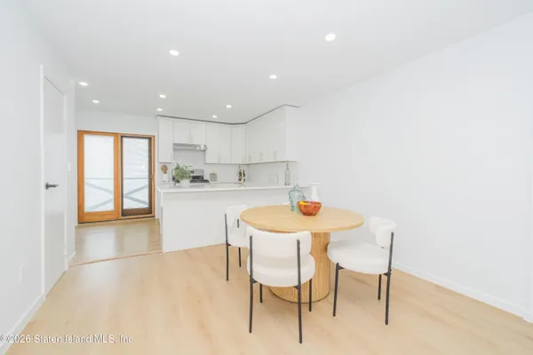 a kitchen with a table and chairs in it