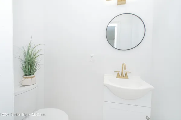 a bathroom with a sink a mirror and a toilet