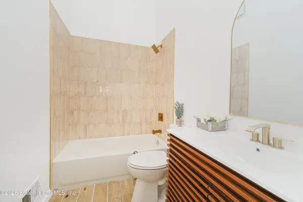 a bathroom with a sink a toilet and a bathtub