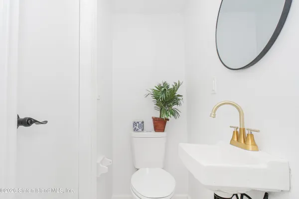 a bathroom with a sink toilet and a mirror