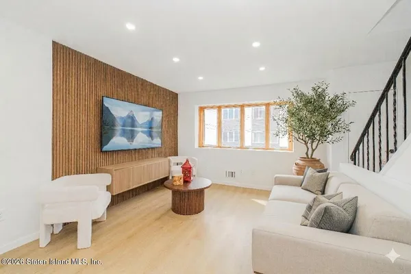 a living room with furniture and a potted plant