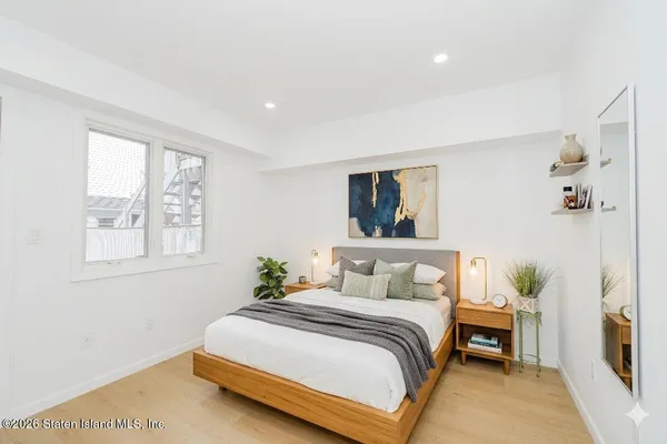 a bedroom with a bed and a painting on the wall