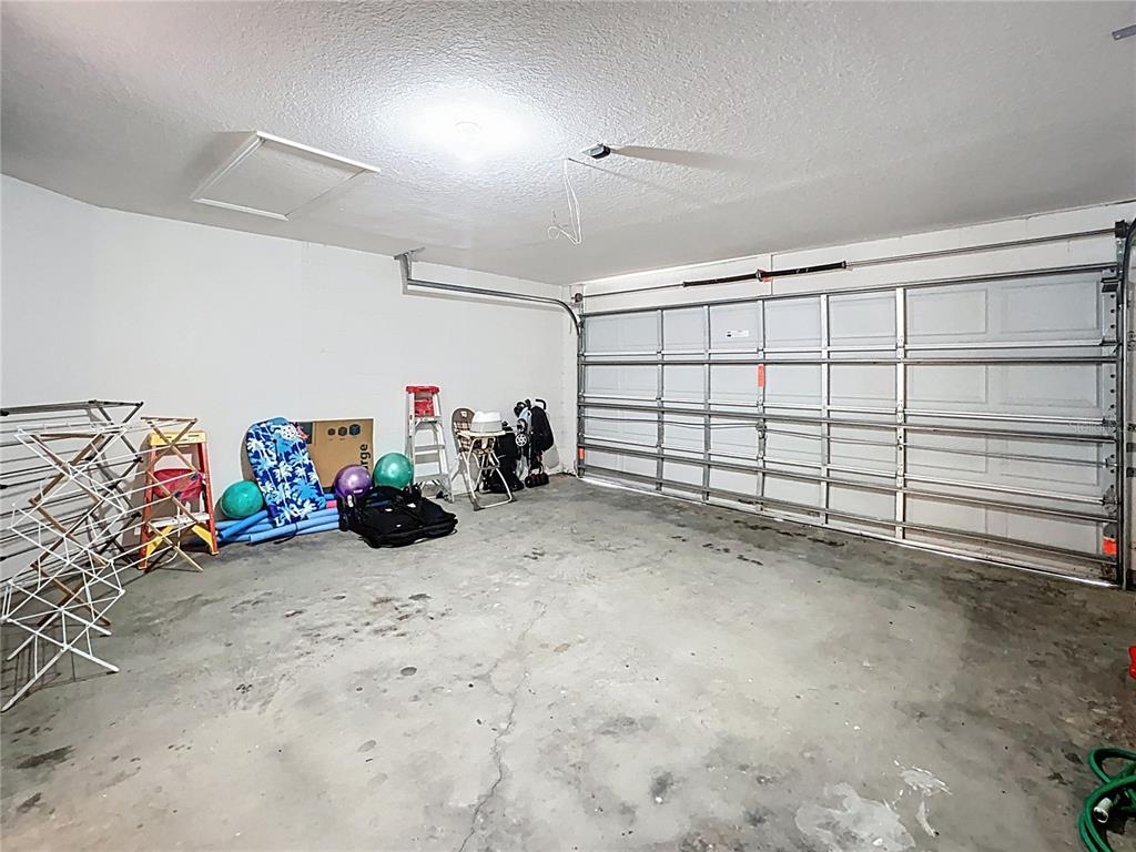 102 Sandy Point Way Clermont, FL 34714 - Photo 26 of 33 a view of a garage with rack and bicycle