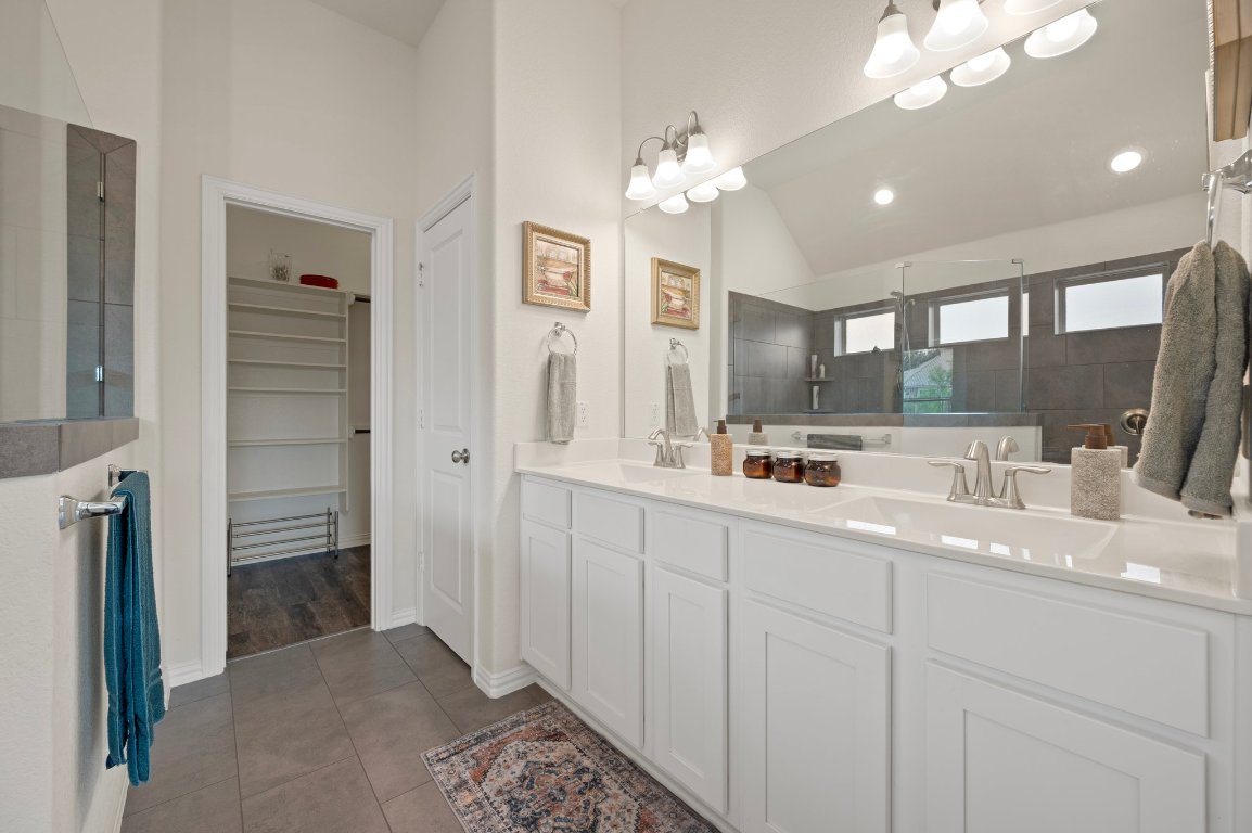 1437 Morning View Road Georgetown, TX 78628 - Photo 14 of 24 a bathroom with a double vanity sink and a mirror