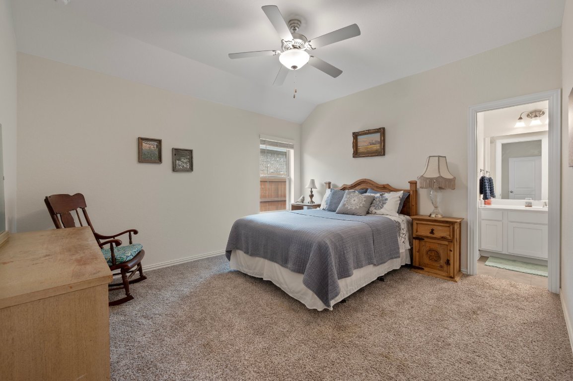1437 Morning View Road Georgetown, TX 78628 - Photo 15 of 24 a spacious bedroom with a bed and a chair