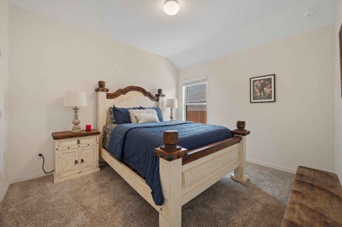 1437 Morning View Road Georgetown, TX 78628 - Photo 21 of 24 a bedroom with a bed and a lamp on the dresser