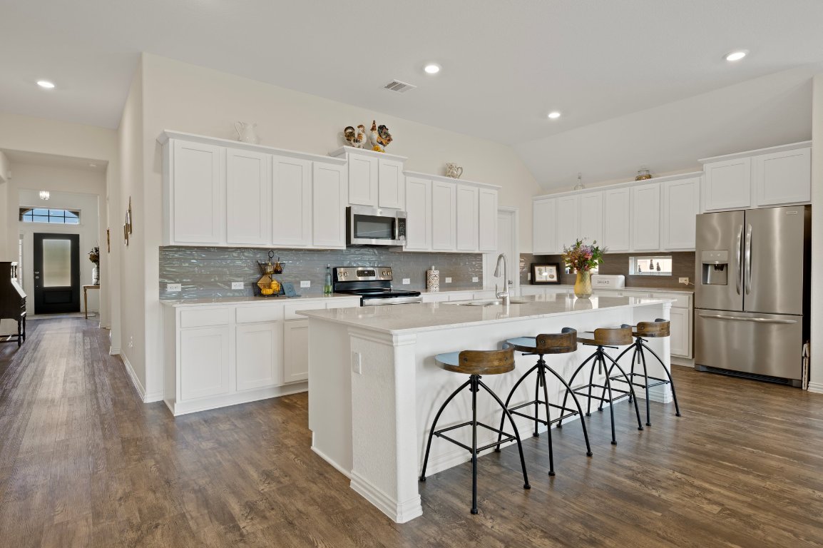 1437 Morning View Road Georgetown, TX 78628 - Photo 3 of 24 a kitchen with white cabinets and stainless steel appliances