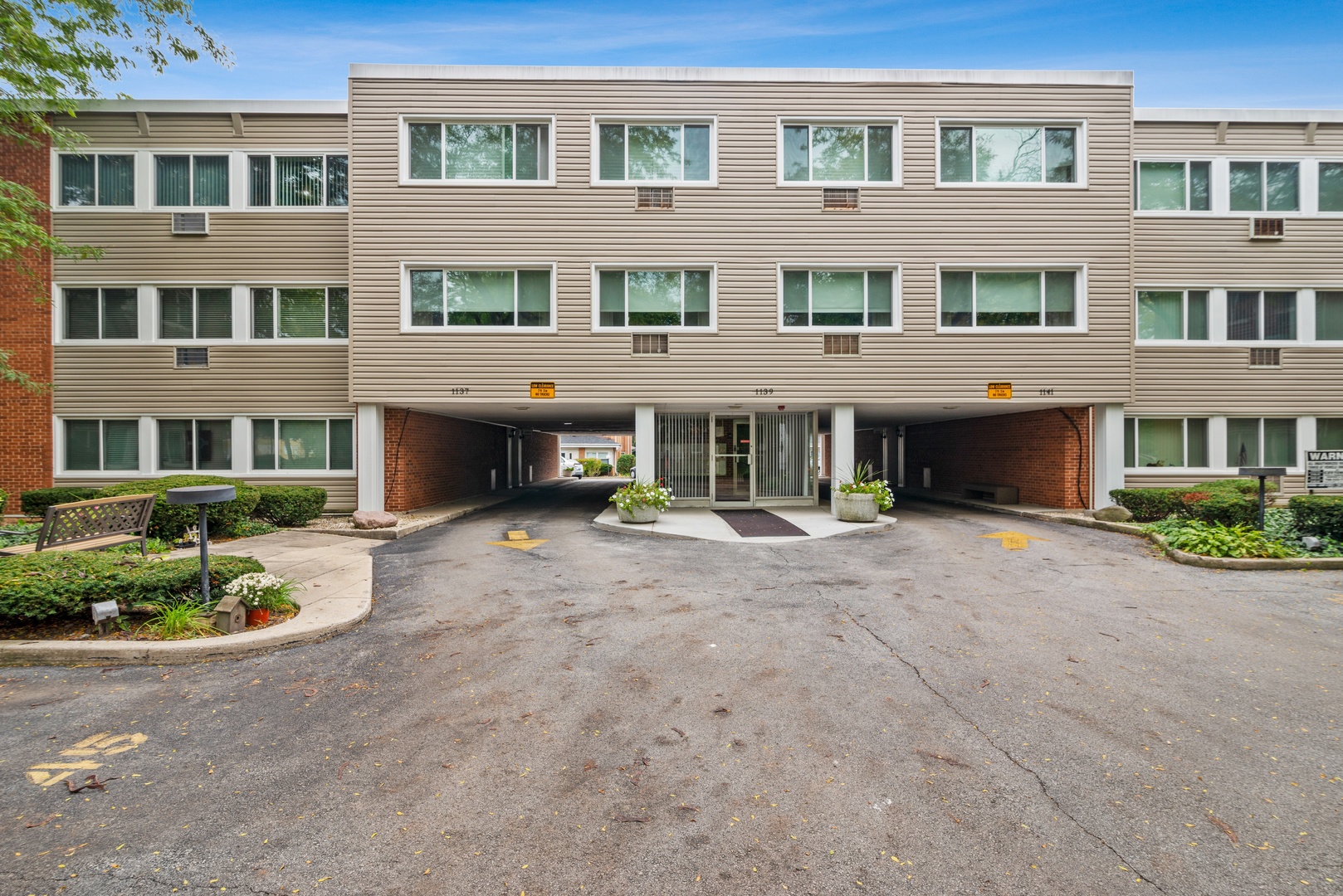 1139 Leavitt Avenue, Unit 212 Flossmoor, IL 60422 - Photo 1 of 10 a front view of a building with a garden
