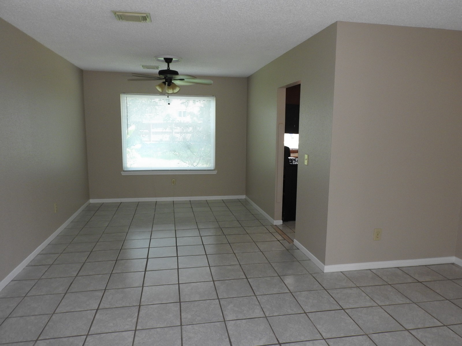 3107 Rimrock Drive Missouri City, TX 77459 - Photo 11 of 32 an empty room with windows and a chandelier fan