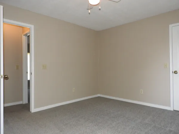 an empty room with a empty space and windows