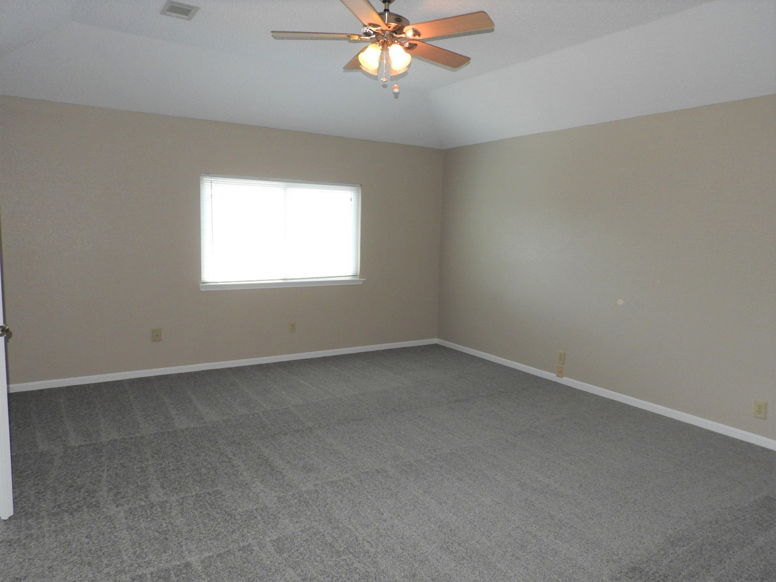3107 Rimrock Drive Missouri City, TX 77459 - Photo 26 of 32 an empty room with a window and a chandelier fan