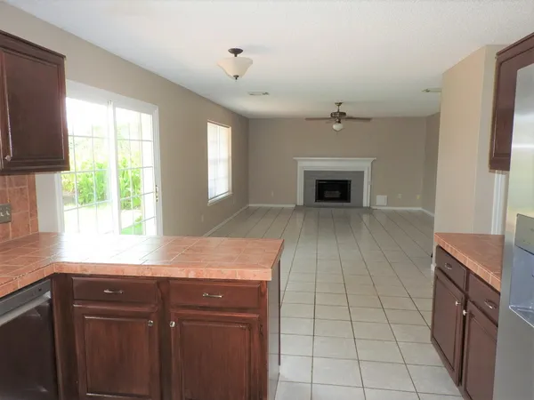 a kitchen with granite countertop a stove sink and cabinets