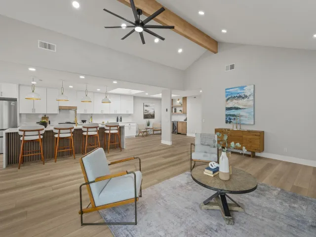 a living room with lots of furniture and kitchen view