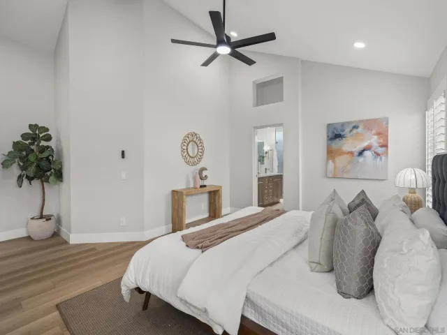 a bedroom with a large bed and a window