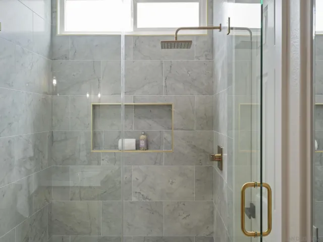 a bedroom with a large bed and a painting on the wall