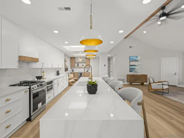 a kitchen with stainless steel appliances lots of counter space and window