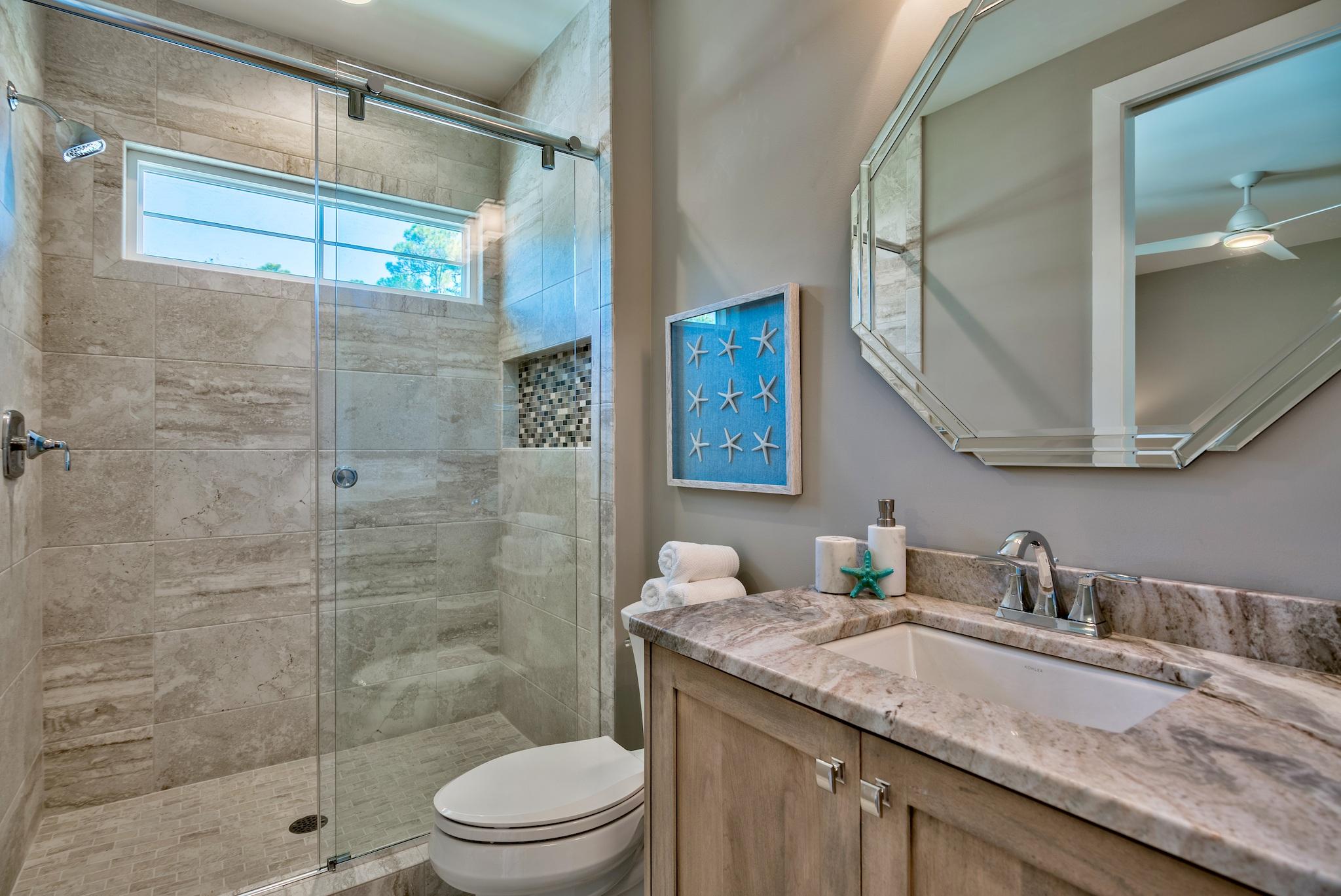 173 Defuniak Street Santa Rosa Beach, FL 32459 - Photo 22 of 28 a bathroom with a granite countertop sink a toilet and shower