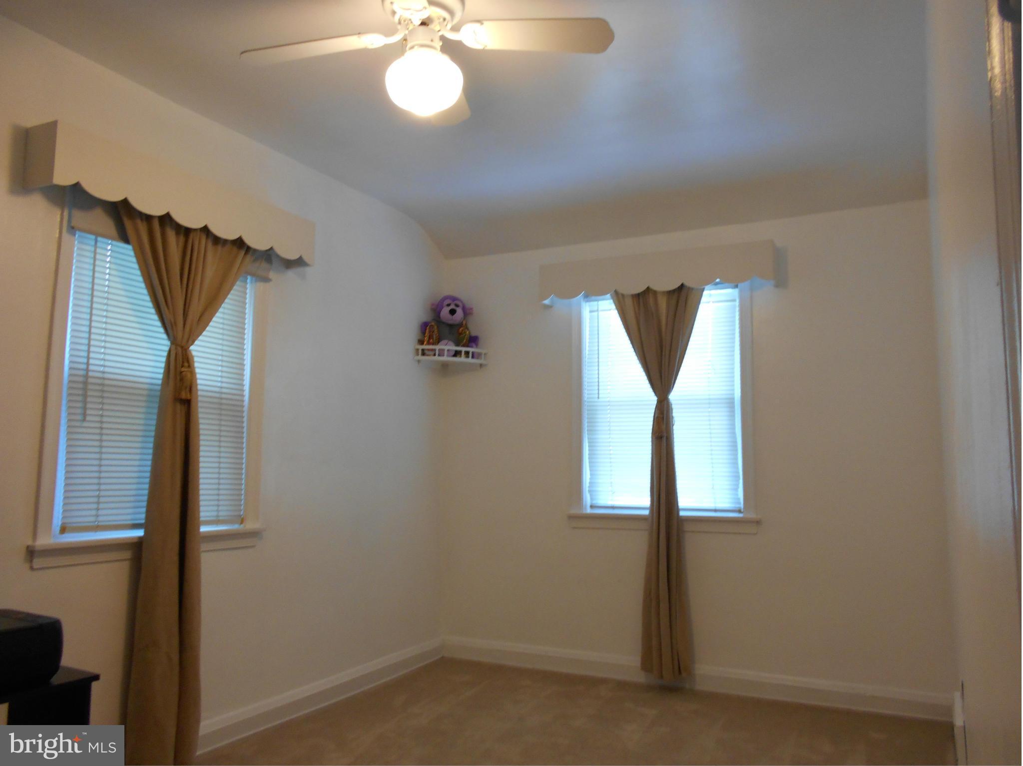 8331 Kavanagh Road Baltimore, MD 21222 - Photo 14 of 28 a view of a hallway with windows and chandelier