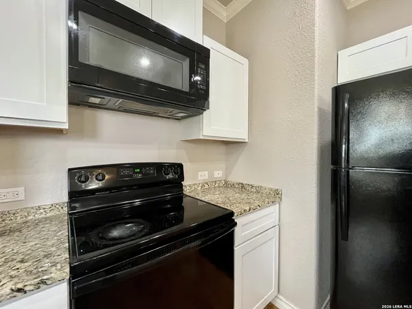 a kitchen with a stove and a microwave