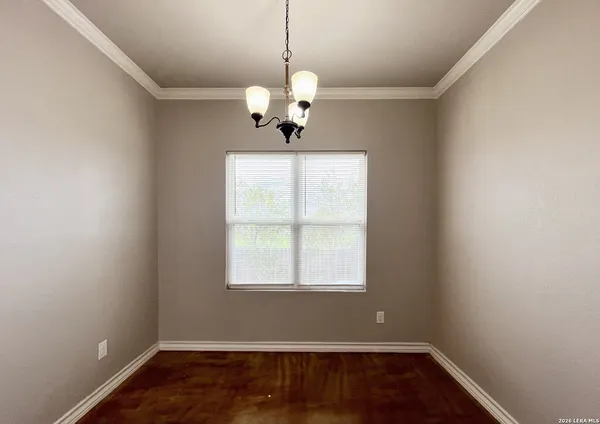 a view of wooden floor and chandelier in a room