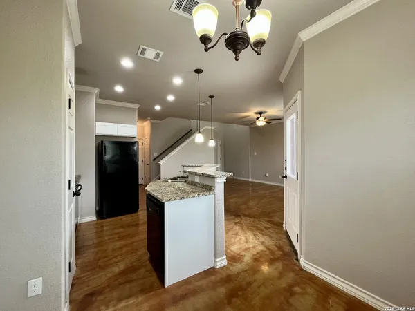 a view of a kitchen with a sink and chandelier