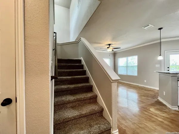 a view of entryway and hall with wooden floor