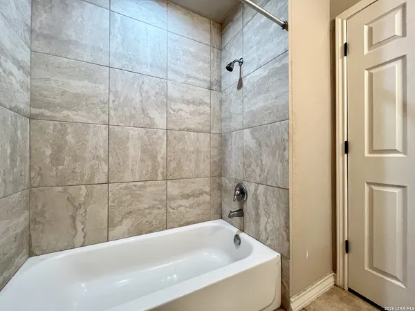 a bathroom with a tub and shower