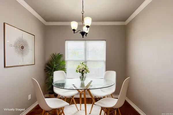 a view of a dining room with furniture wooden floor and a chandelier
